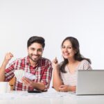 focused-indian-young-couple-accounting-calculating-bills-discussing-planning-budget-together-using-online-banking-services-calculator-checking-finances_466689-9002