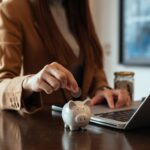 woman-hand-holding-coin-with-pig-piggy-bank-saving-financial-accounts-concept_533878-66